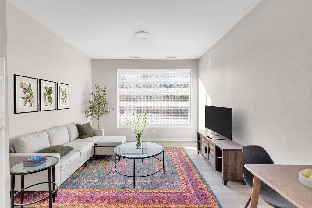 a living room with a white couch and a tv