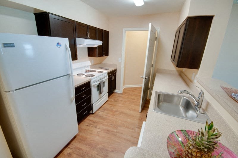 a small kitchen with a refrigerator and a sink
