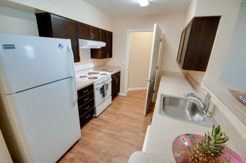 a small kitchen with a refrigerator and a sink