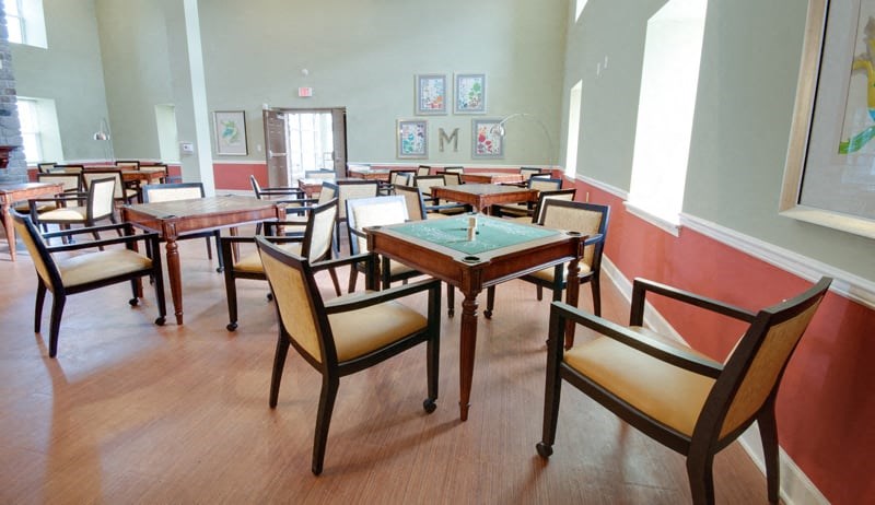 a dining room with tables and chairs and a pool table