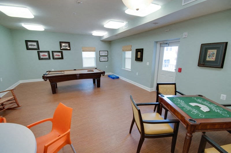 a game room with a pool table and a billiard