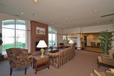A living room with a chair, couch, and lamp.