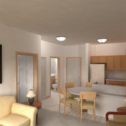 A living room with a yellow couch and a dining table with chairs.