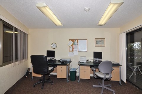 A room with two desks and two chairs.