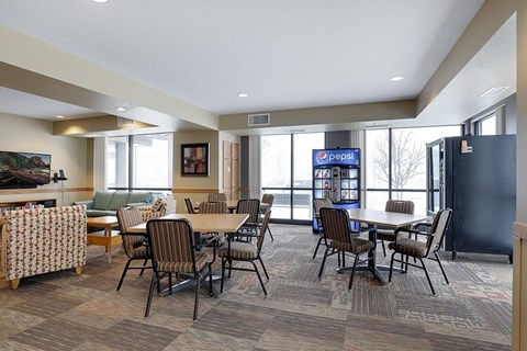 A room with a Pepsi machine in the corner.