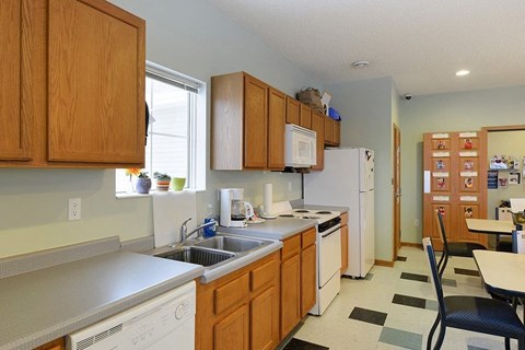 A kitchen with wooden cabinets and white appliances.