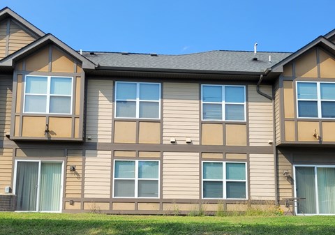 A row of townhouses with a clear blue sky above.