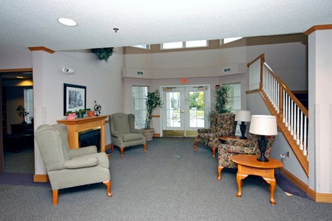A living room with a fireplace and comfortable seating.