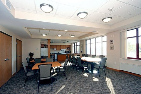 A conference room with a long table and chairs.