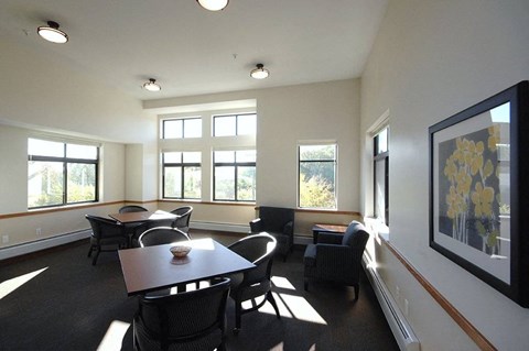 A dining room with a table and chairs.