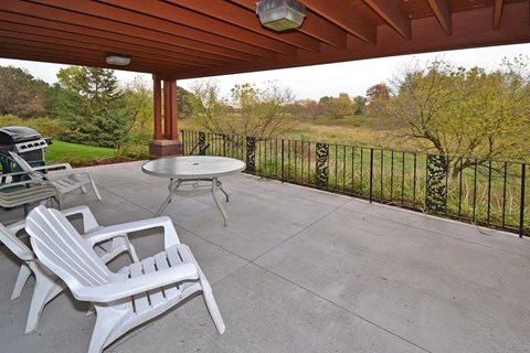 A patio with a table and chairs.