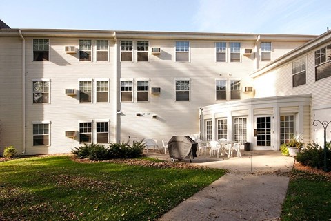 A white building with a white lawn in front.