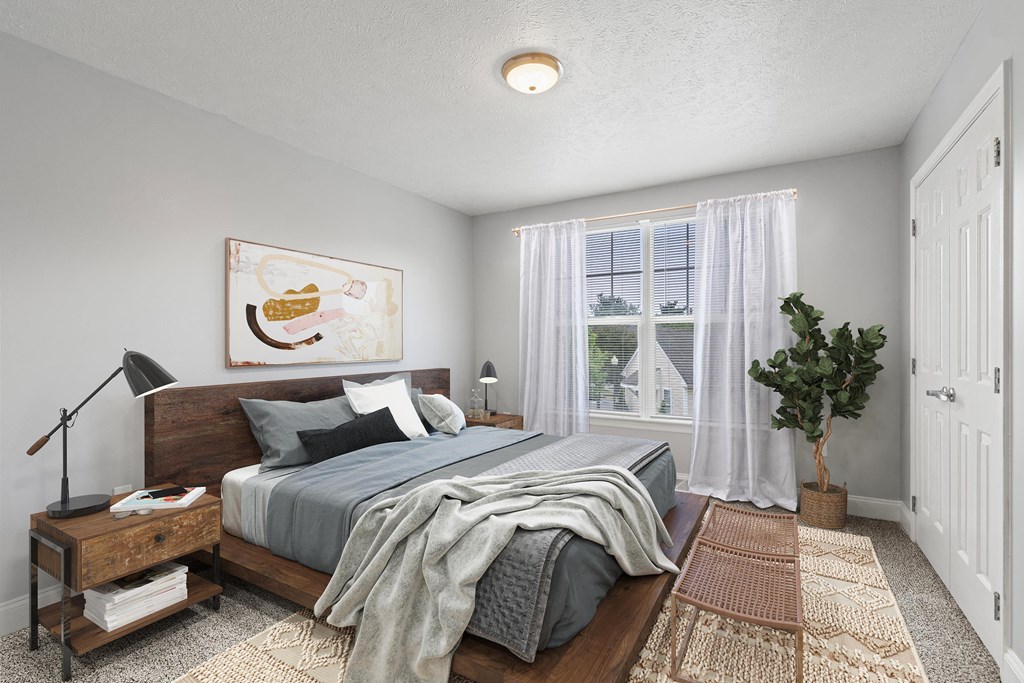 a bedroom with a large bed and a large window