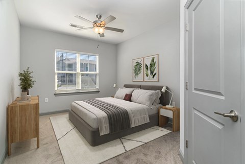 A bedroom with a bed, nightstand, and window at The Parker Myrtle Beach, Myrtle Beach, SC
