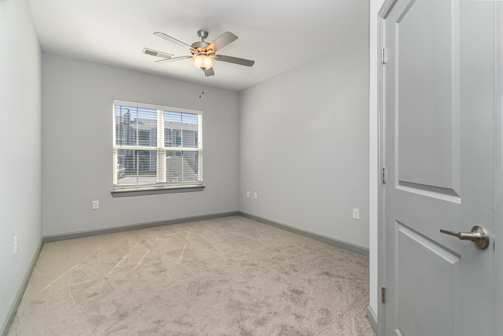 a bedroom with a ceiling fan and a window at The Parker Myrtle Beach, Myrtle Beach, SC, 29588