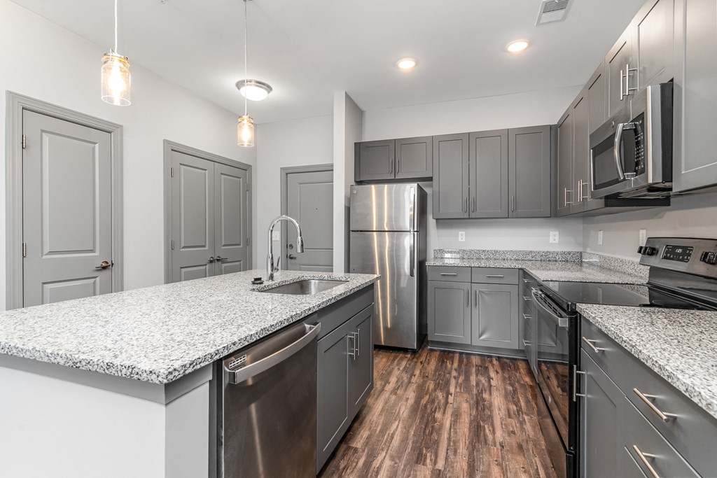 Kitchen with gray cabinets and white countertops at The Parker Myrtle Beach, South Carolina