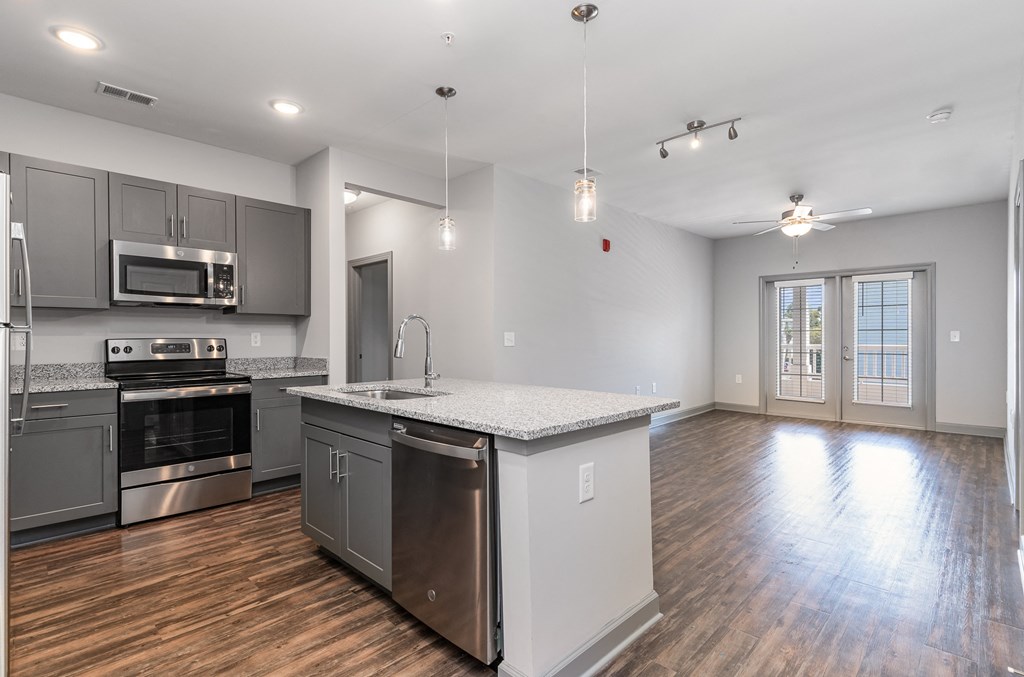a kitchen and living room with an island and stainless steel appliances at The Parker Myrtle Beach, South Carolina