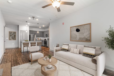 A living room with a couch, chairs, and a coffee table.