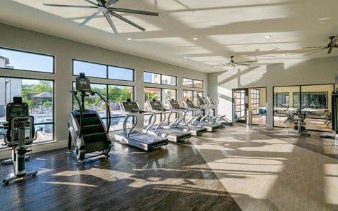 Gym with big windows and cardio equipment at The Eddy at Riverview, Georgia, 30126