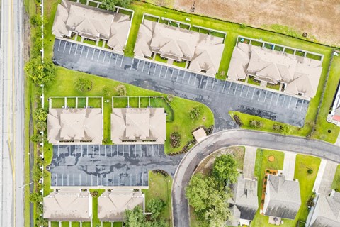 A residential area with houses and a parking lot.
