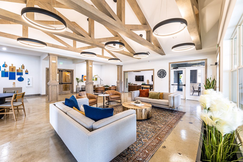 a living room with couches and chairs and a rug at The Parker Austin, Pflugerville