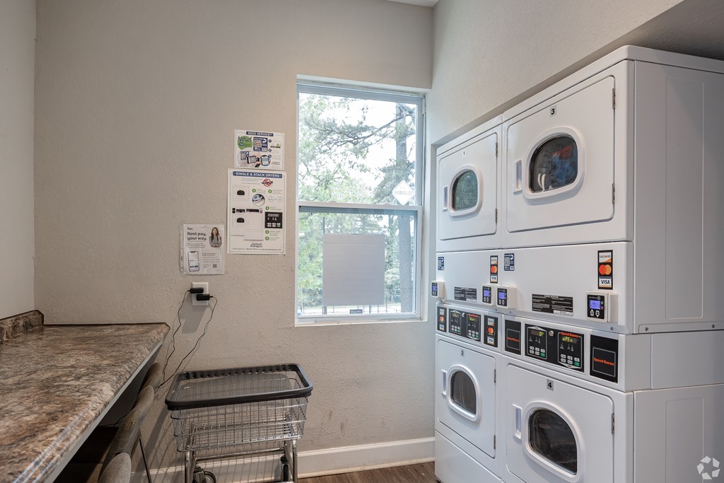 A Laundry Room With a Washer and Dryer at Avondale Place Apartments, Georgia, 30002