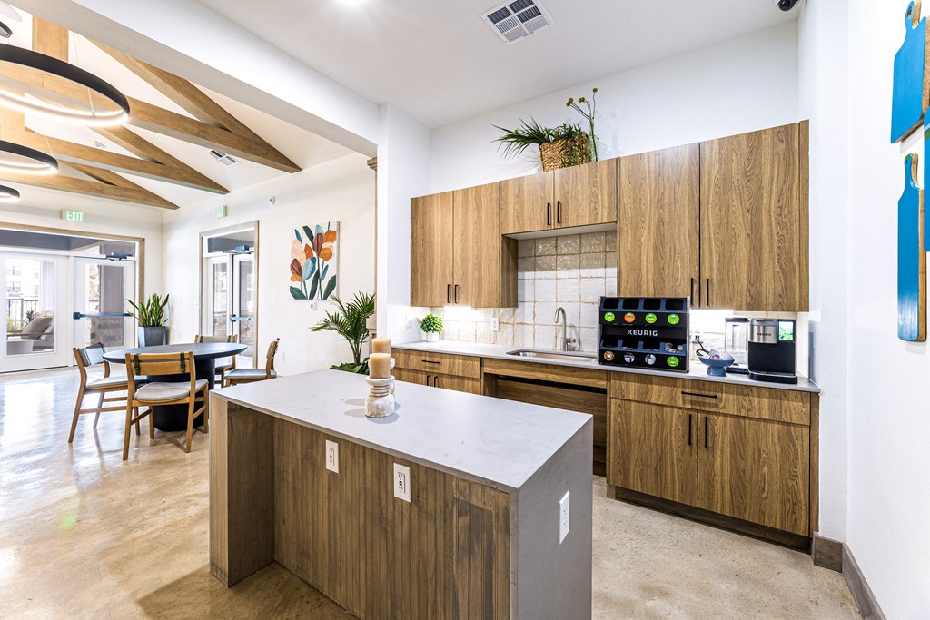 Kitchen with wooden cabinets and a white counter top Kitchen with wooden cabinets and a white counter top at The Parker Austin, Pflugerville