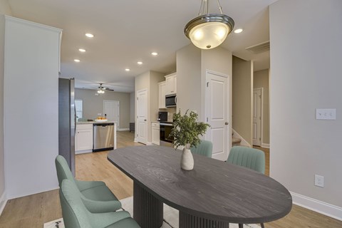 A modern dining room with a round table and chairs.