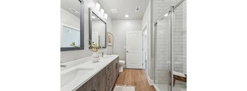 A bathroom with a white sink and a mirror.