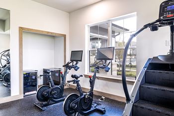 a gym with exercise bikes and a treadmill at The Parker Austin, Pflugerville, 78660