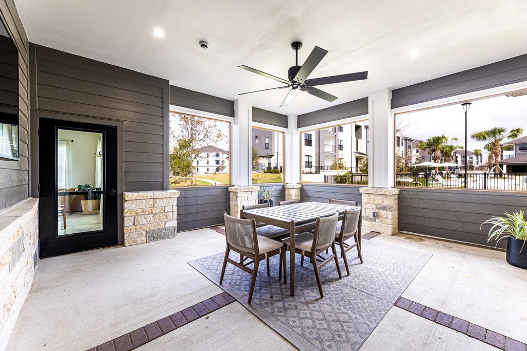 Dining area with a table and chairs and a ceiling fan Dining area with a table and chairs and a ceiling fan at The Parker Austin, Pflugerville, Texas