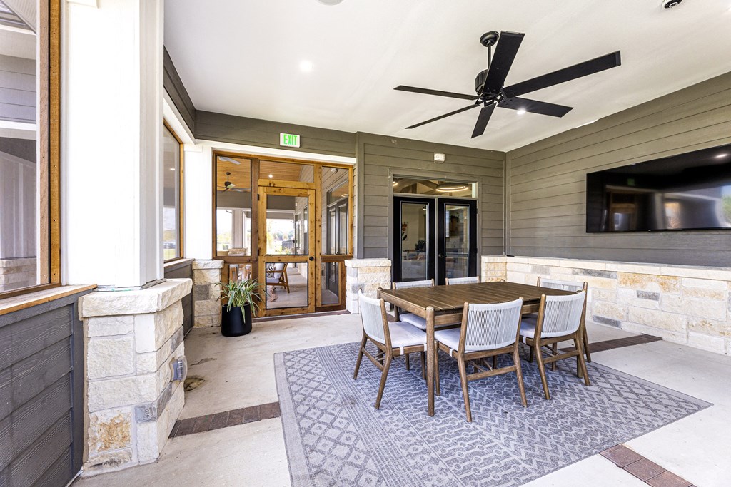 a dining area with a table and chairs and a tv at The Parker Austin, Pflugerville, 78660