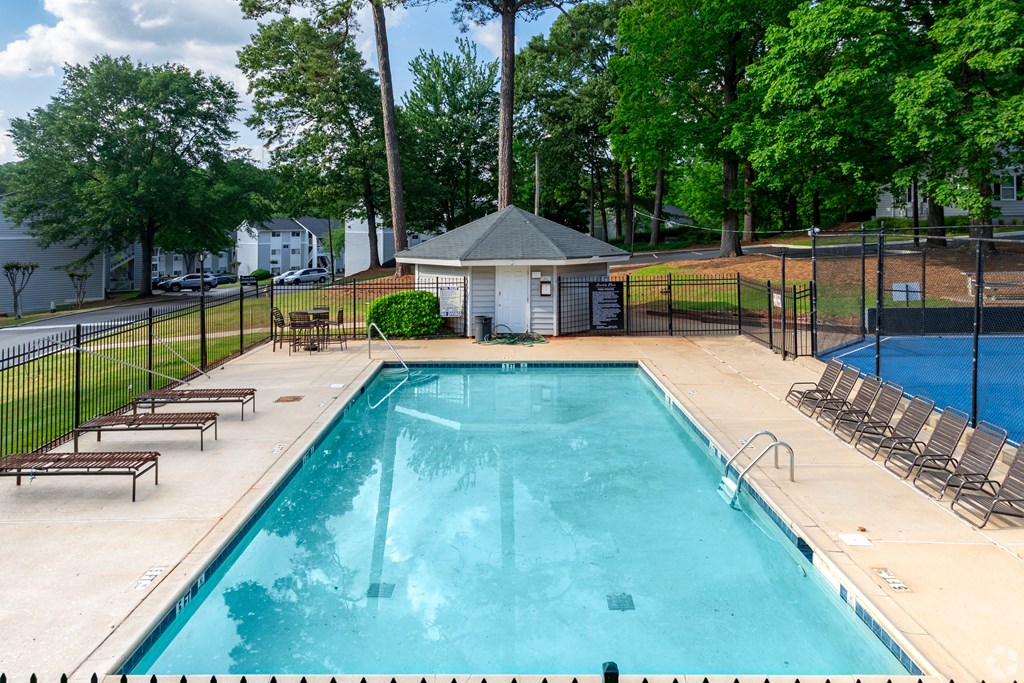A Swimming Pool With Relaxing Area at Avondale Place Apartments, Georgia