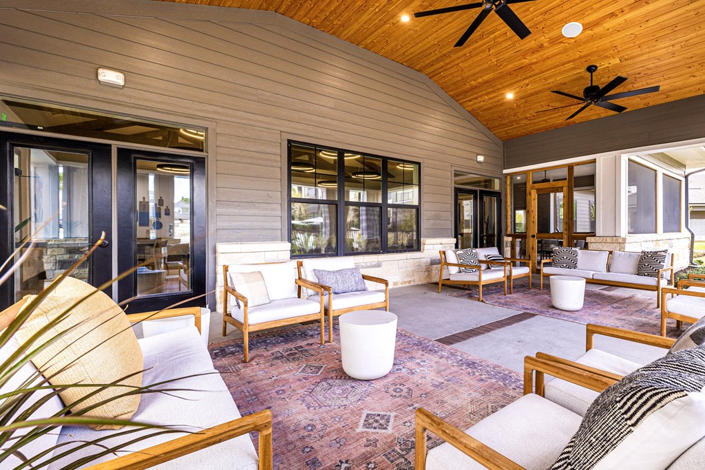 a covered patio with furniture and a ceiling fan at The Parker Austin, Pflugerville, Texas