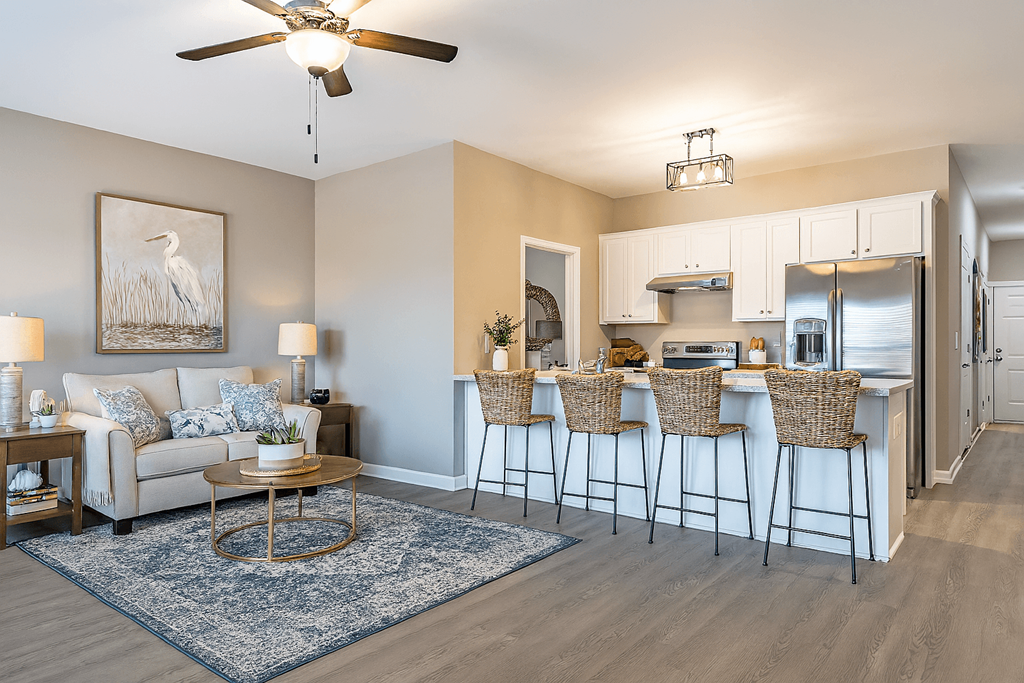 A living room with a bar area and a ceiling fan.