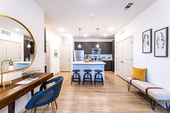 a living room with a kitchen and a dining room at The Parker Austin, Pflugerville, Texas