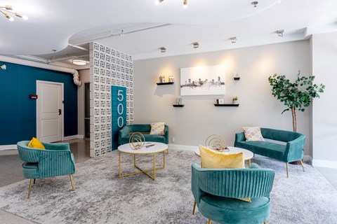 Lobby with blue chairs and yellow and green furniture at 500 Fifth Apartments, Nashville, Tennessee