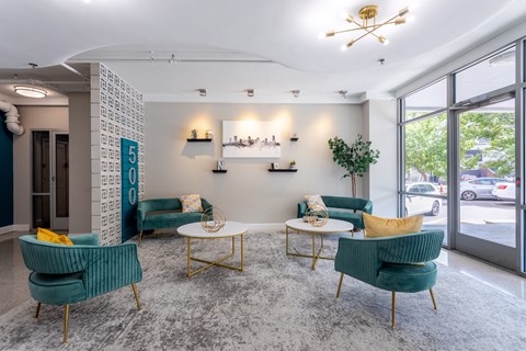 Lobby with chairs and tables and a large window at 500 Fifth Apartments, Nashville, TN, 37219