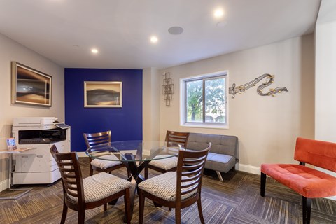 Living room with a dining room table and chairs and a kitchen with a microwave at 500 Fifth Apartments, Tennessee, 37219