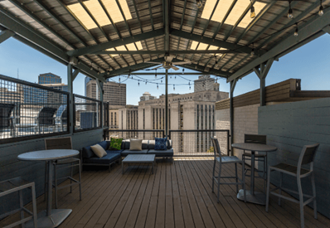 a roof deck with a view of the city