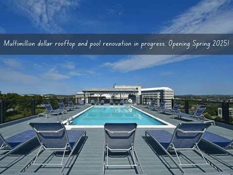 A swimming pool surrounded by lounge chairs on a rooftop at 500 Fifth Apartments, Nashville, Tennessee