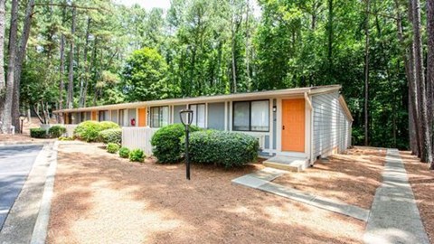 A row of houses with orange front doors.