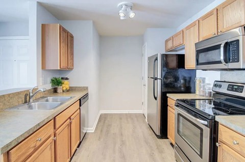A kitchen with wooden cabinets and stainless steel appliances.