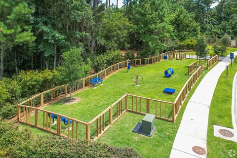 A playground with a wooden fence and a slide.