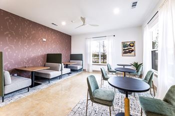 a living room with couches tables and chairs and a window at The Parker Austin, Pflugerville, 78660