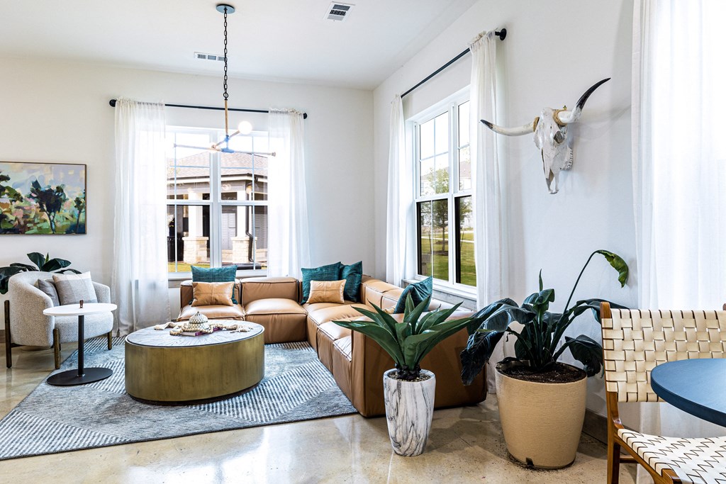 Living room with a couch and a table and some plants at The Parker Austin, Pflugerville