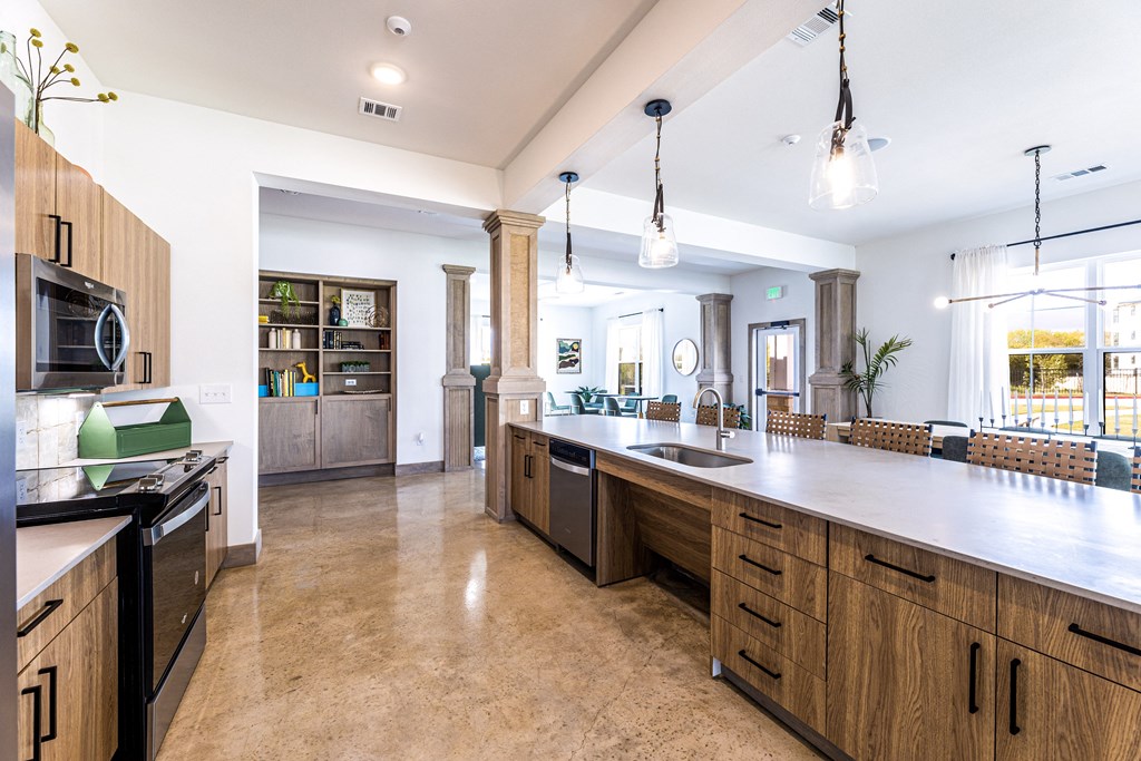 a large kitchen with a large counter top and a sink at The Parker Austin, Texas