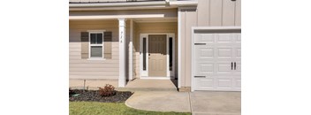 A house numbered 716 with a white garage door.
