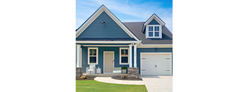 A blue house with a white garage door.
