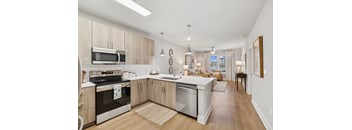 A modern kitchen with wooden cabinets and stainless steel appliances.